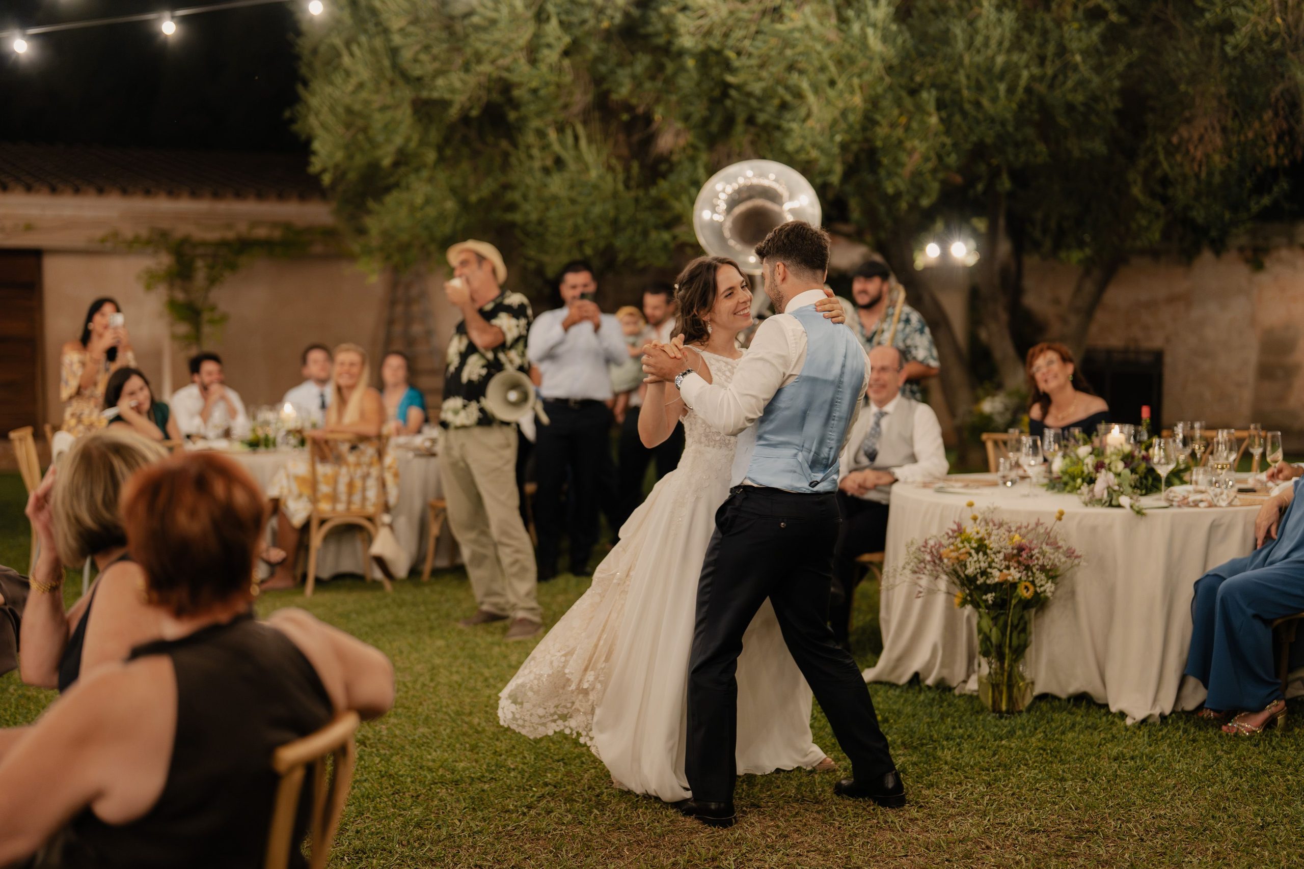 A dance in the garden as the guests look on.