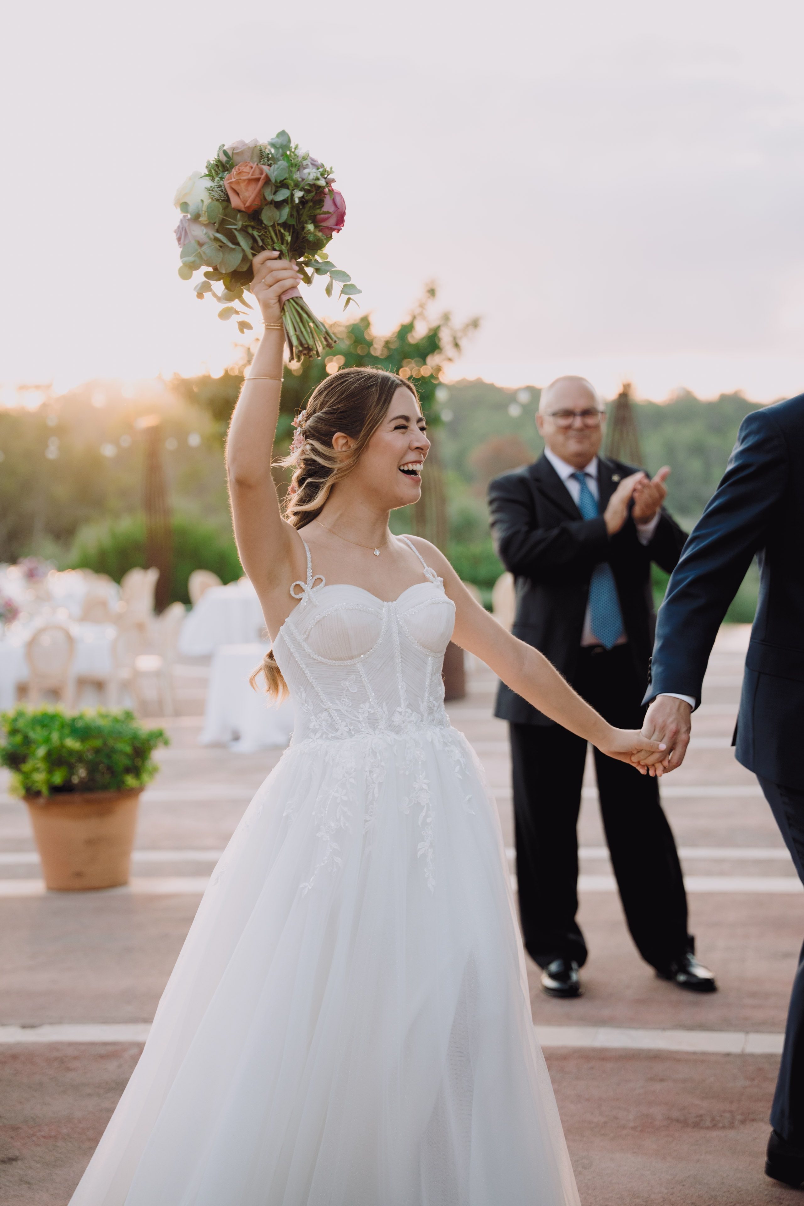 The bouquet raised high in celebration.