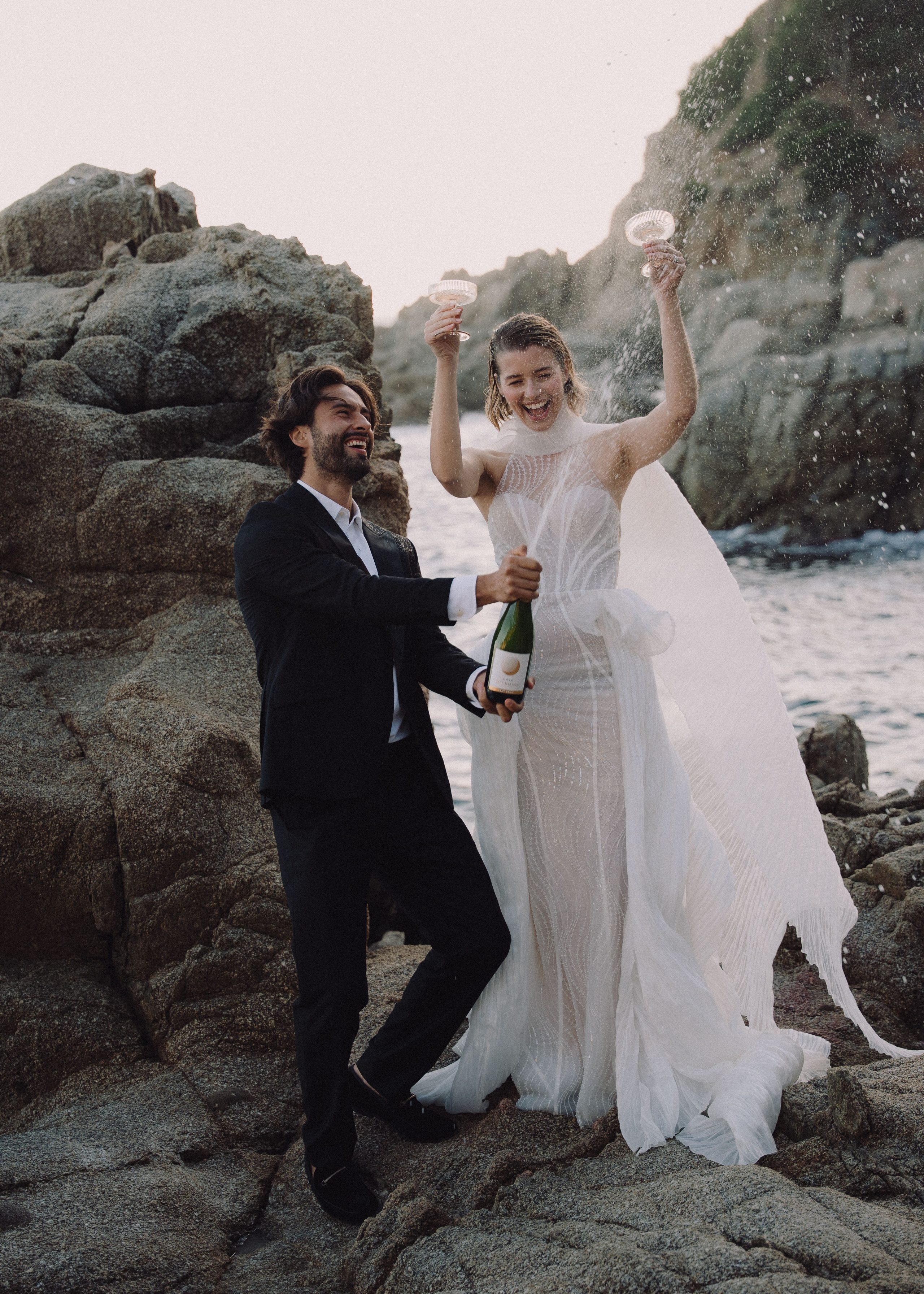 Celebrating together on the rocks beside the sea.