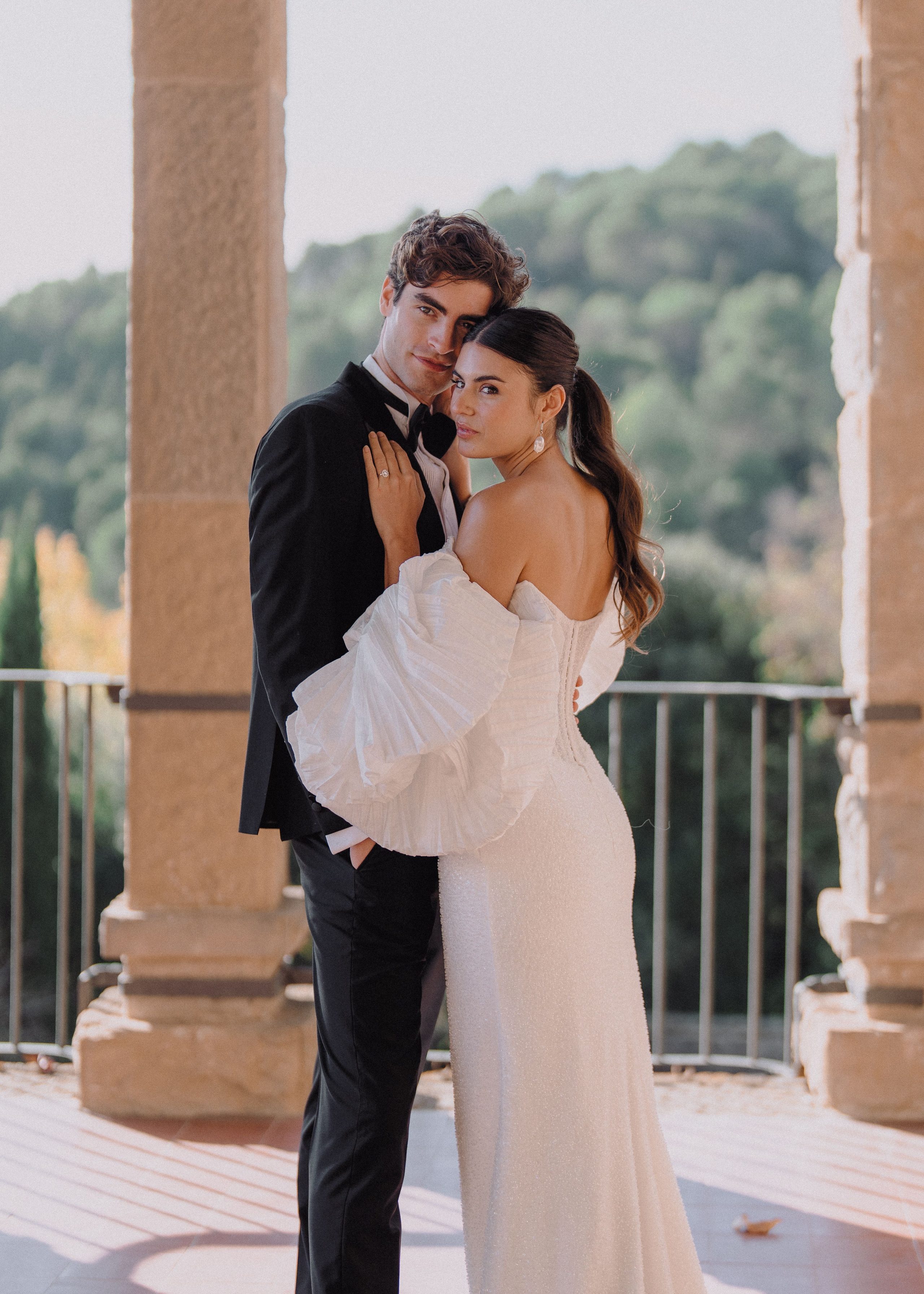 An embrace framed by stone columns.