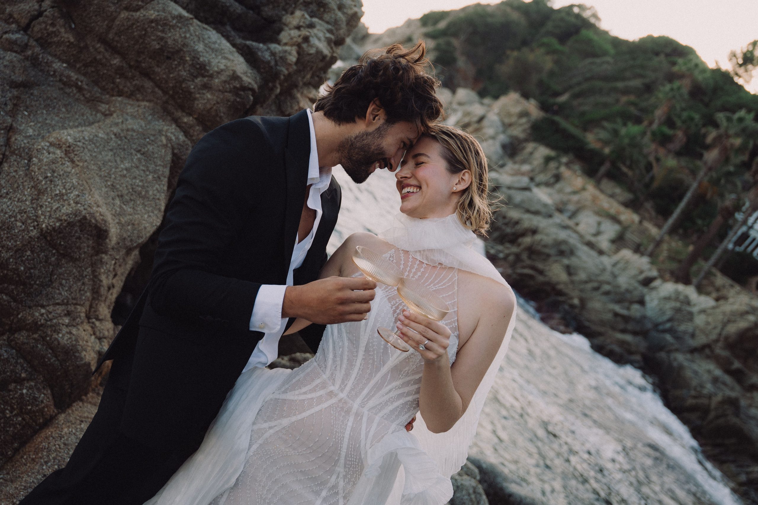 A shared laugh among the coastal rocks.