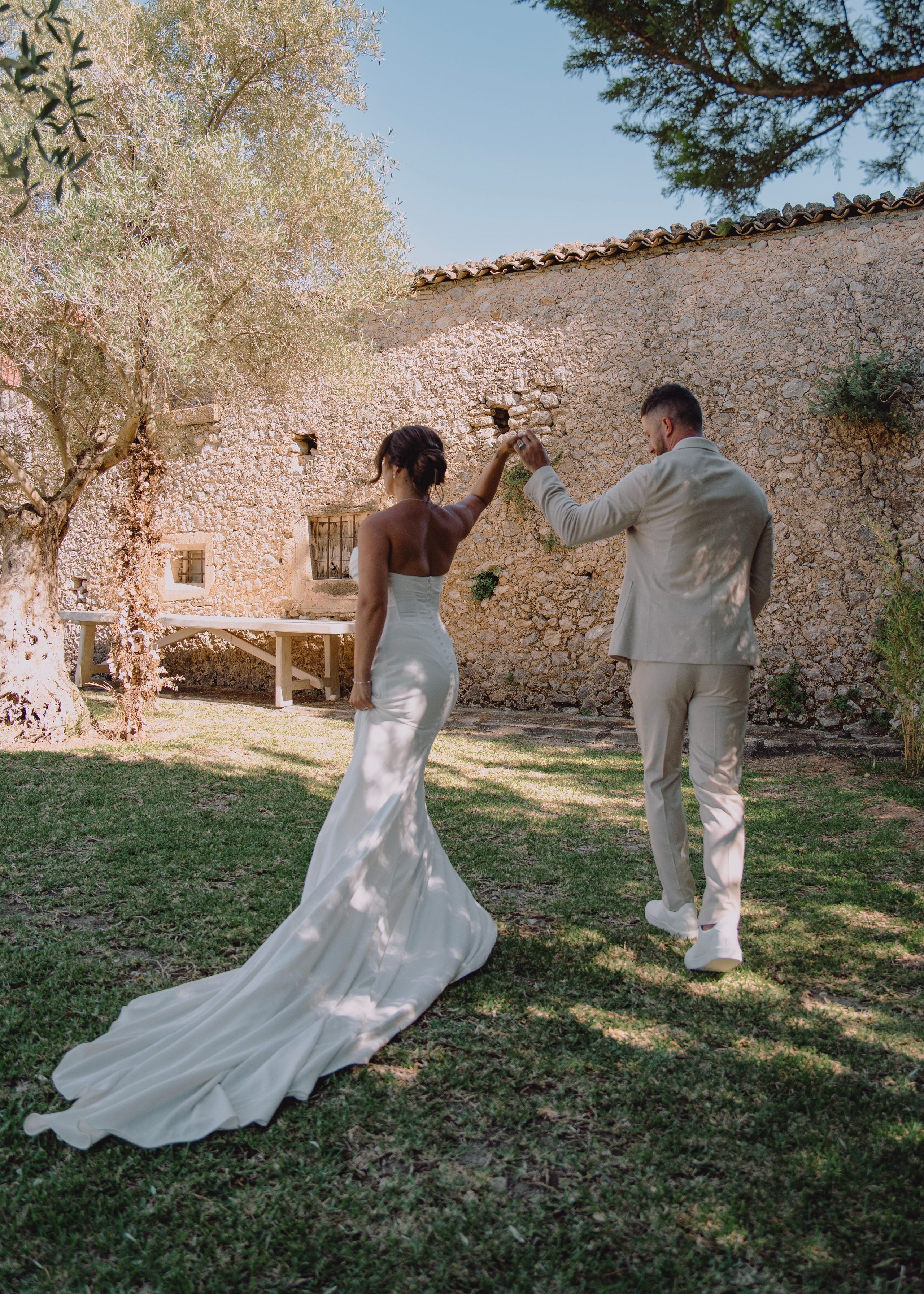 A twirl in the garden beside a stone wall.