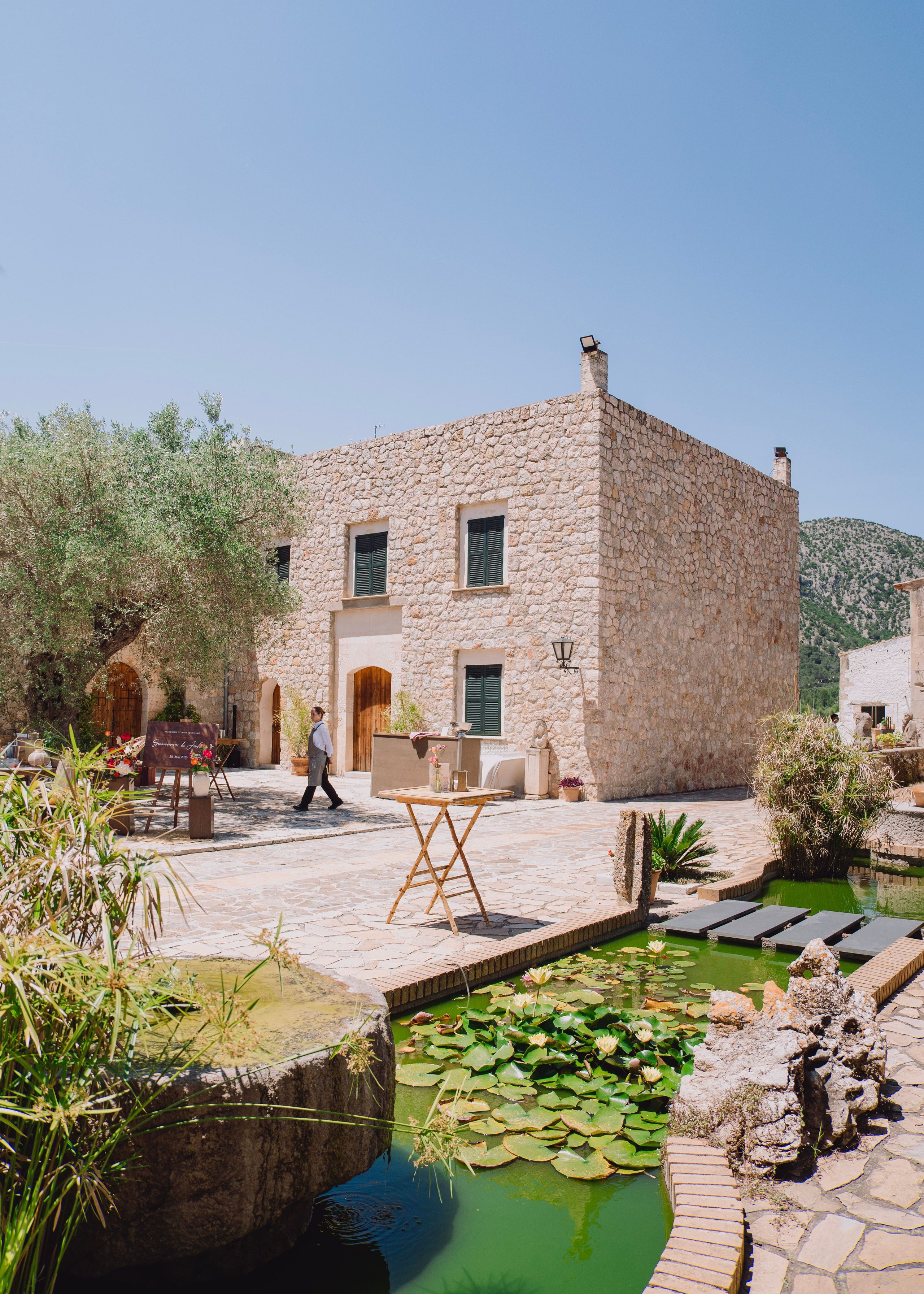 A stone house and a quiet lily pond.