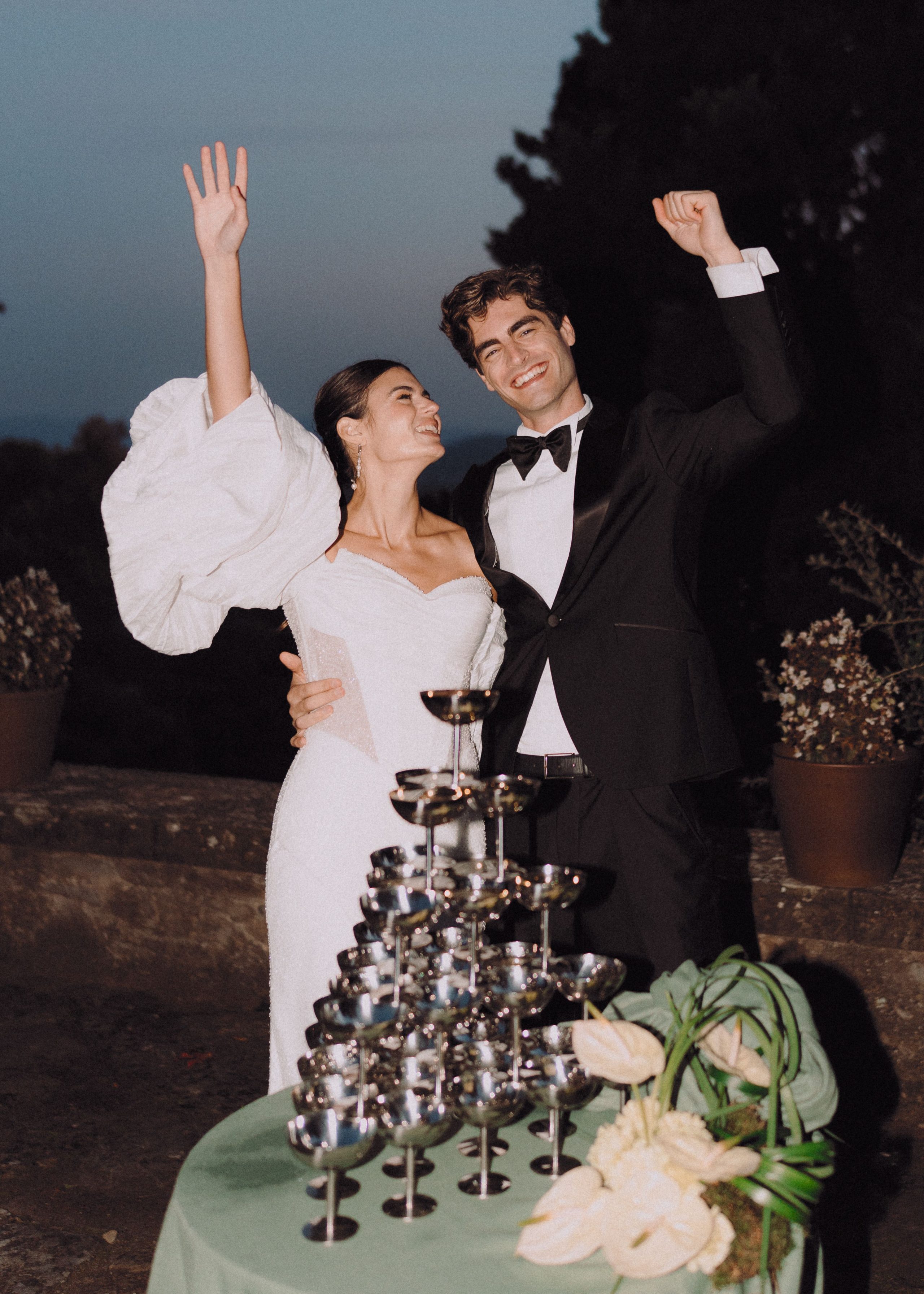 A toast beside a tower of champagne glasses.