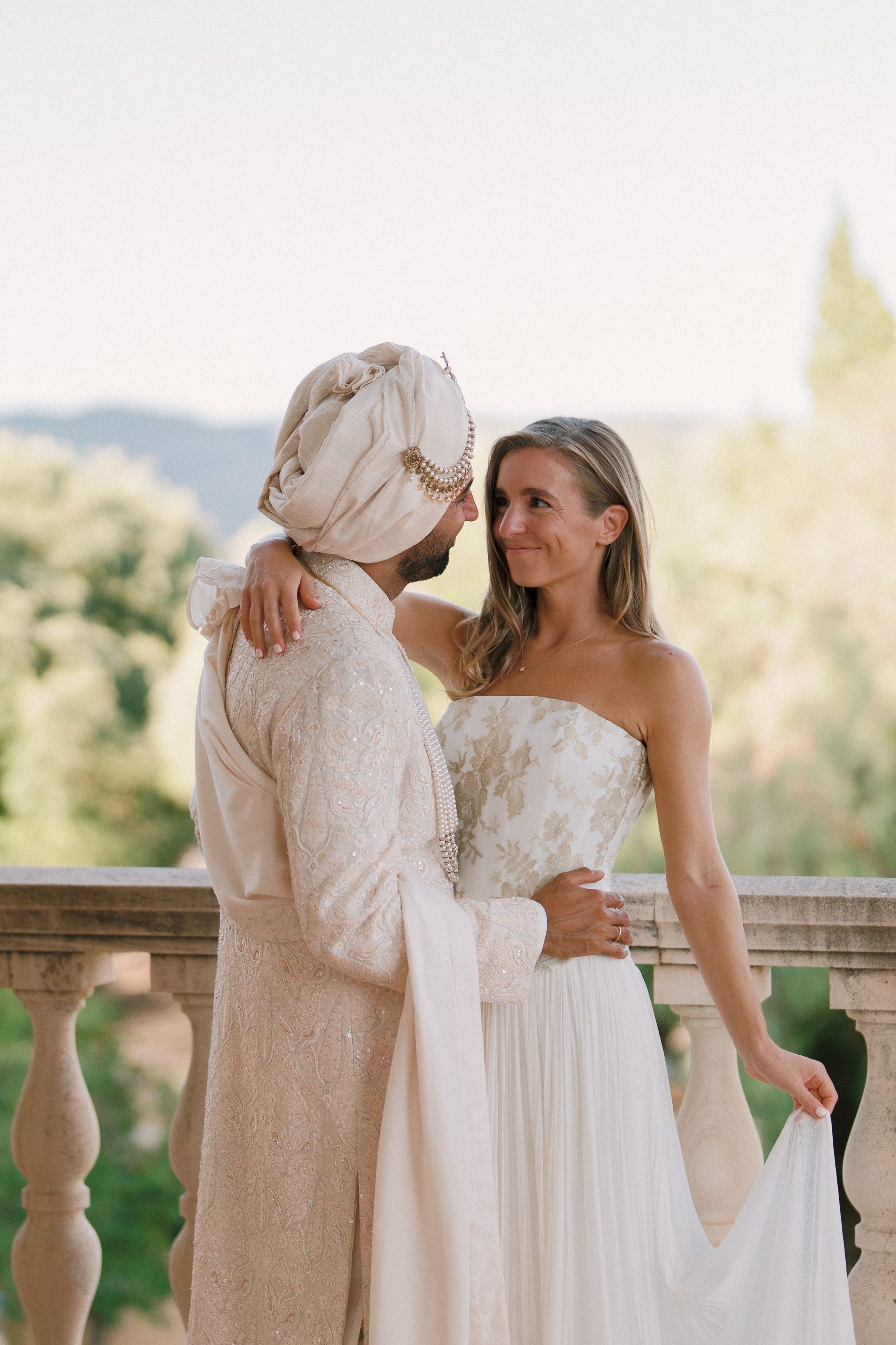A quiet embrace on a sunlit terrace.